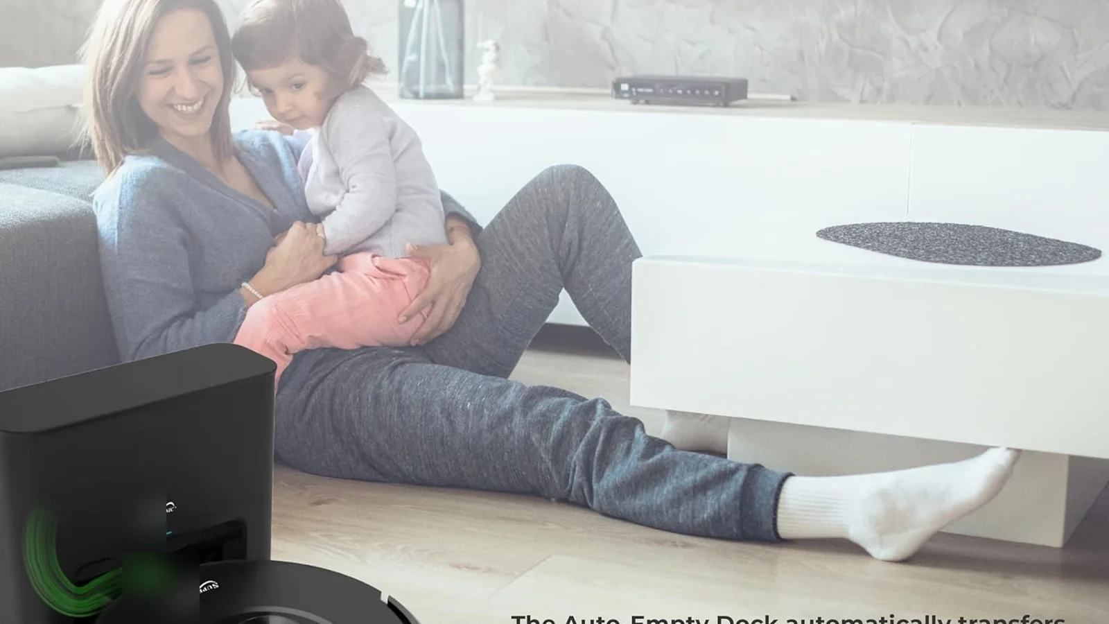 SDL40 robot vacuum docked at its self-emptying station in a living room