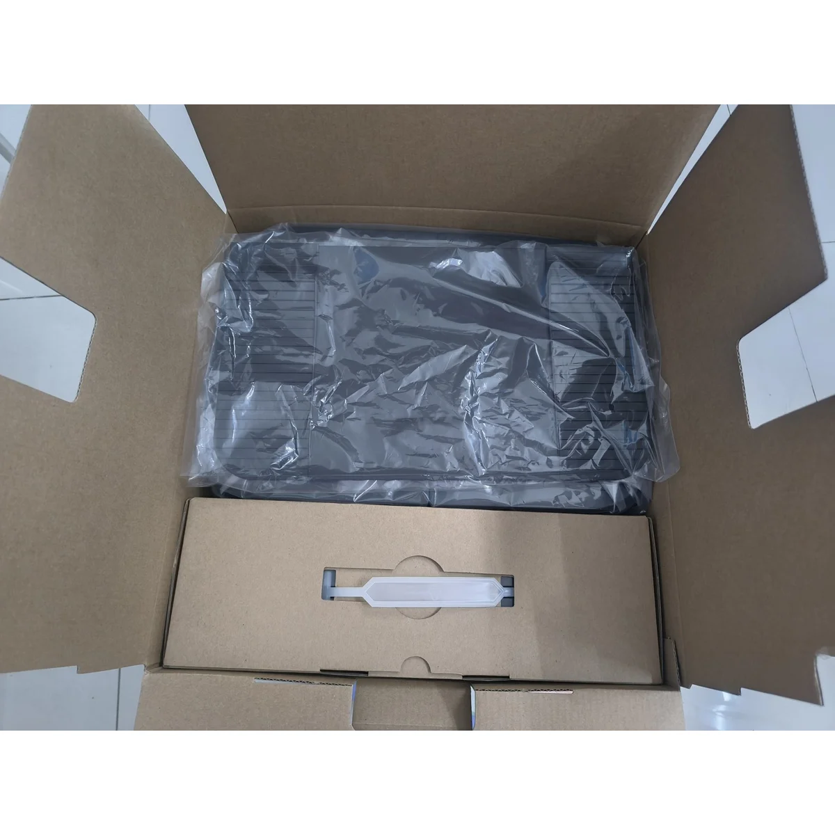 SW75 station in protective wrap inside an opened shipping carton